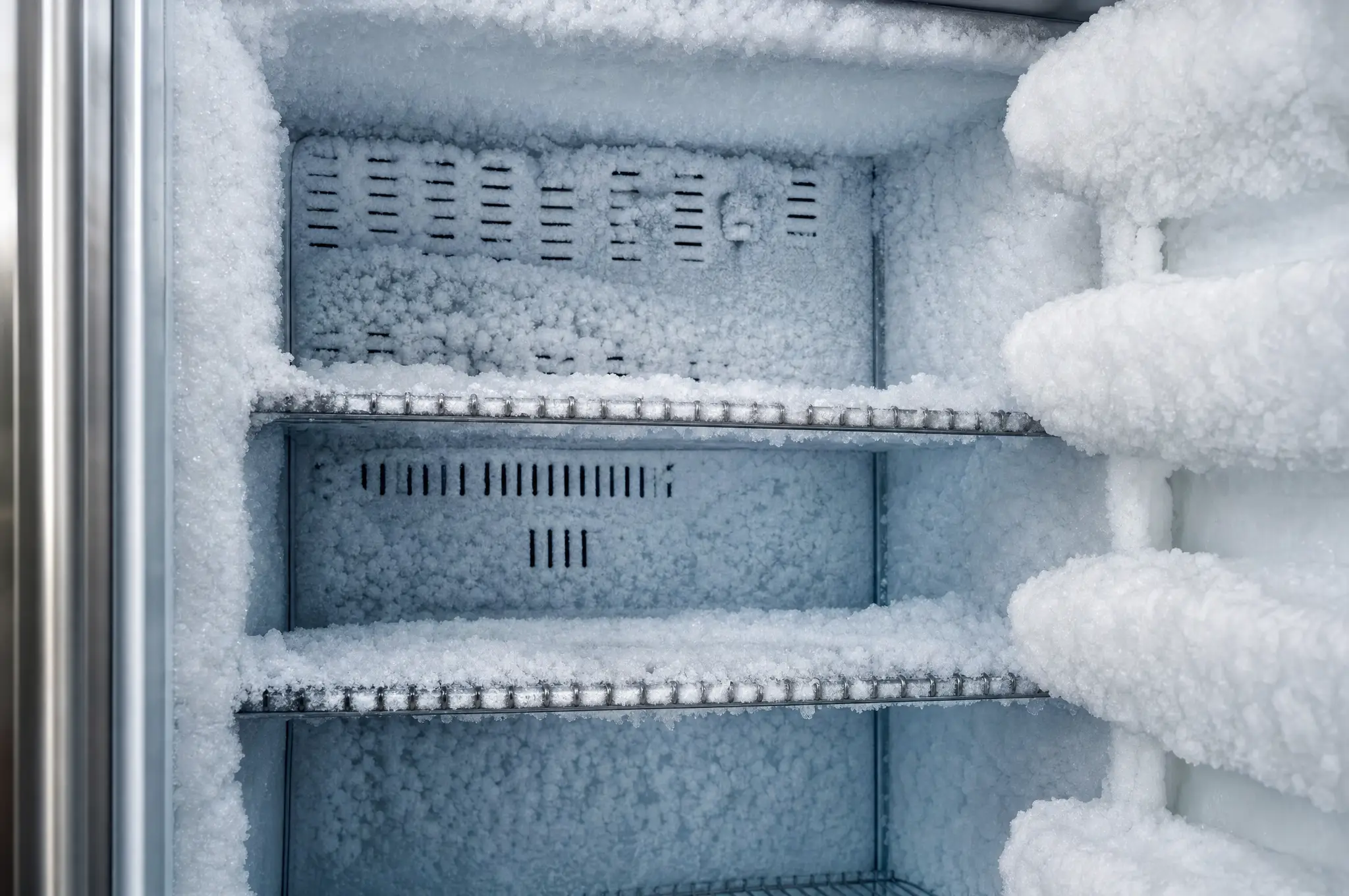 Frost and ice buildup inside a freezer compartment